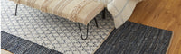 Layered rugs in bedroom